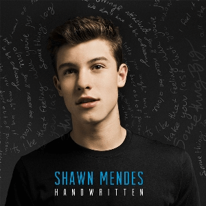Shawn Mendes in front of dark background with 'Handwritten' at the bottom center